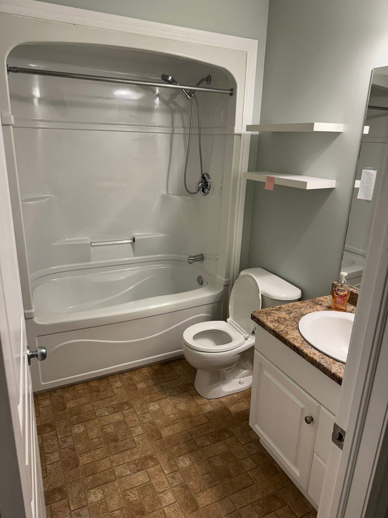 Tub and shower combo with a granite-top vanity