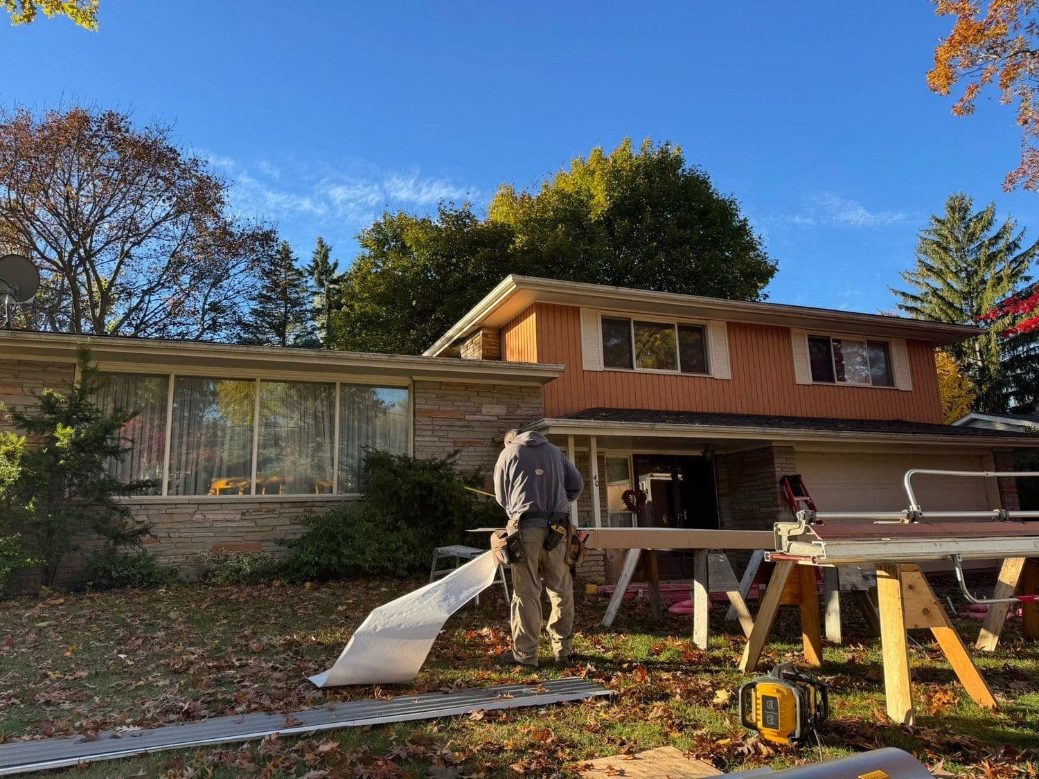 Exterior siding and eavestrough installation in progress